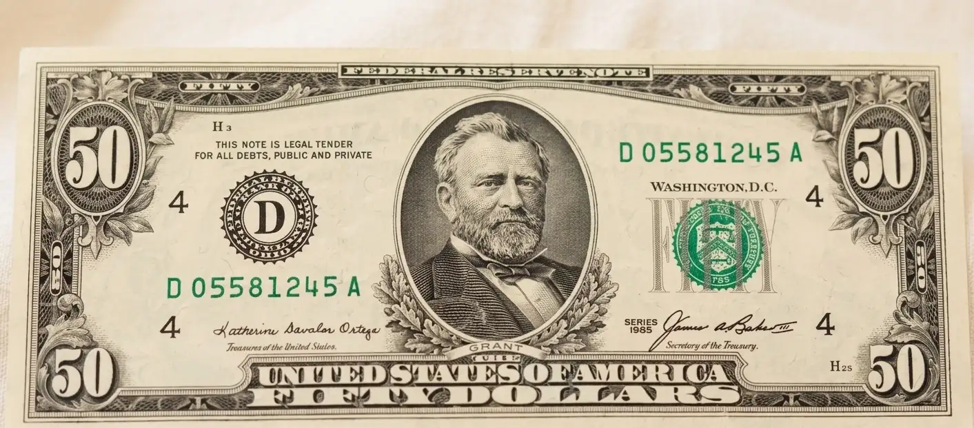 Minimal scene with 50 dollar bill centered